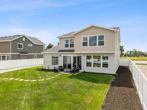 Back of property with stucco siding, a fenced backyard, a patio area, an outdoor living space, and a shingled roof
