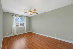 Spare room with light wood-style flooring and a ceiling fan