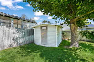 View of shed featuring a fenced backyard