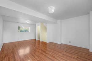 Spare room with wood finished floors and baseboards
