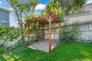 Fenced backyard with a patio and a pergola