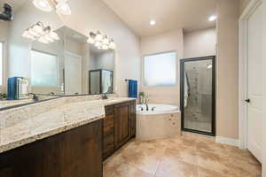 Full bath with vanity, a garden tub, a stall shower, light tile patterned floors, and recessed lighting