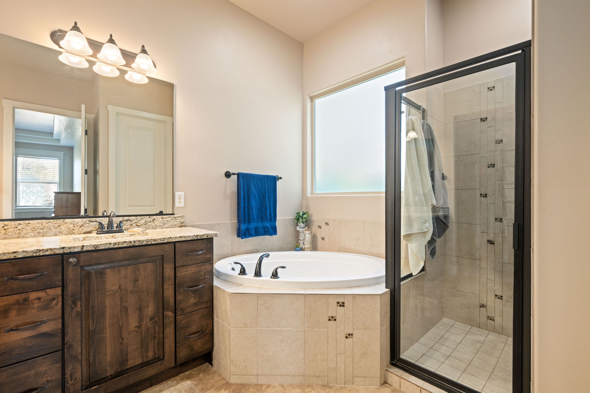 Full bathroom with a bath, a shower stall, vanity, and light tile patterned floors