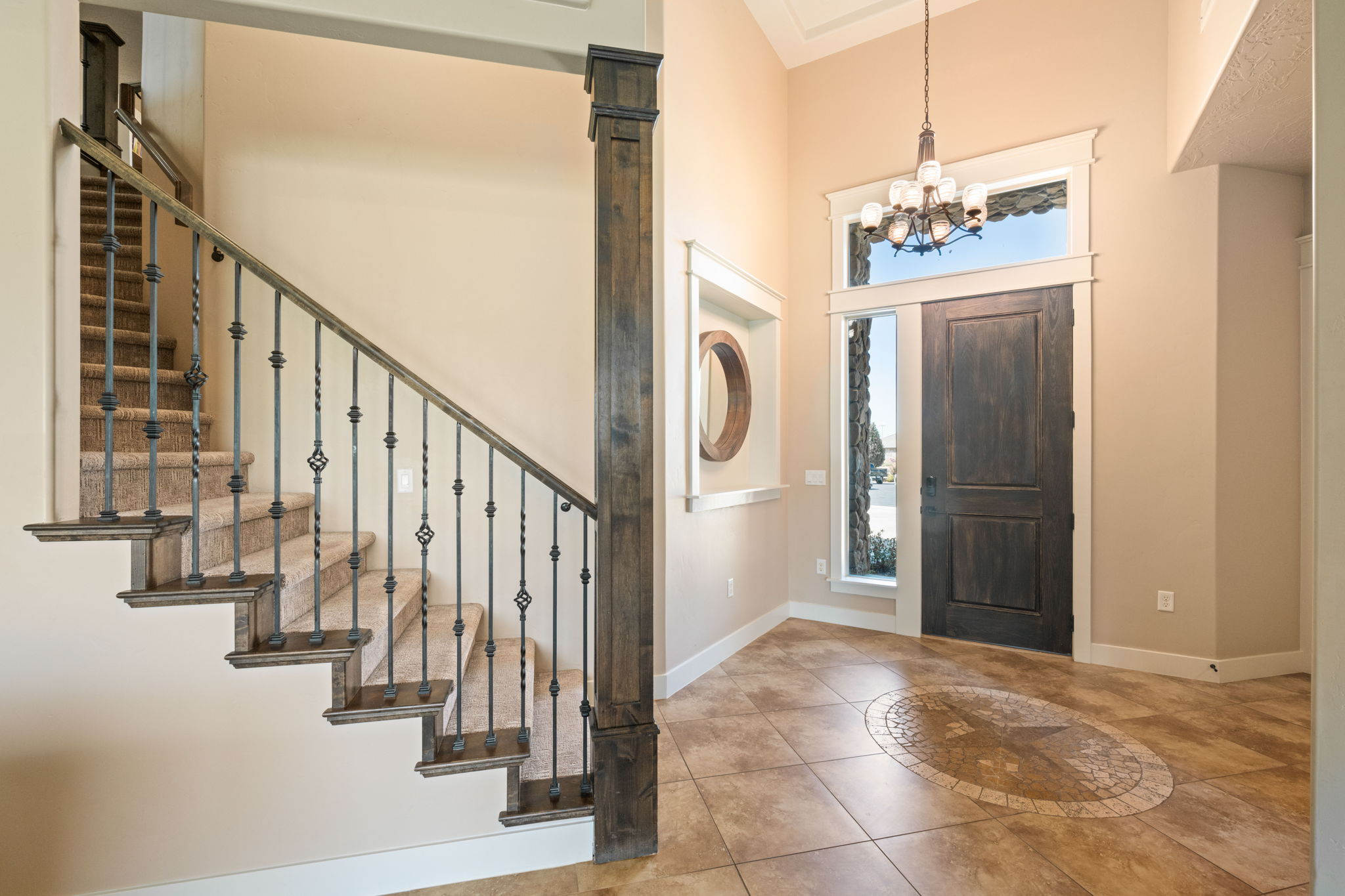 Entrance foyer with light tile patterned floors, a chandelier, and a high ceiling