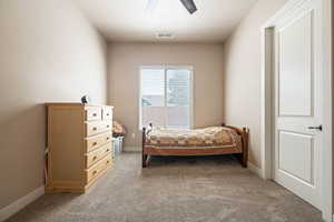 Bedroom with light carpet and ceiling fan