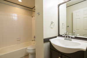 Bathroom with shower / washtub combination, vanity, tile patterned floors, and recessed lighting