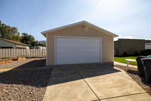Detached garage featuring concrete driveway
