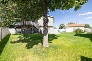 Fenced backyard with stairway, a deck, and a patio area