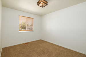 Carpeted empty room with baseboards