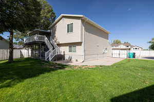 Back of house with a patio, stairway, and a wooden deck