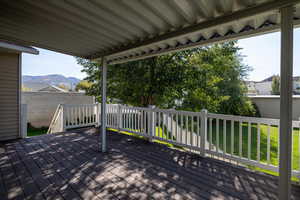 Deck featuring a mountain view and a lawn