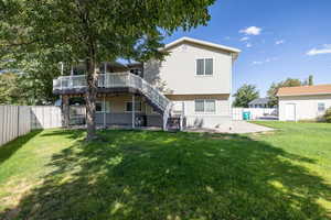 Rear view of property with a patio area, a fenced backyard, stairway, and a deck