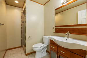 Full bathroom featuring ornamental molding, vanity, a stall shower, light tile patterned flooring, and recessed lighting