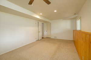 Carpeted empty room featuring recessed lighting, a textured ceiling, and ceiling fan