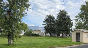 Green lawn with a mountain view and an community mailboxes right across the street