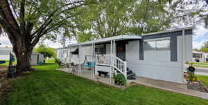 Side view of property with shed and a patio area