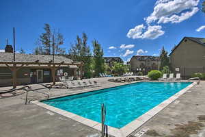 Community pool featuring a residential view and a patio