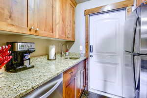 2nd Kitchen featuring stainless steel appliances and light stone counters