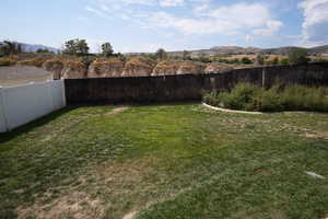Fenced backyard featuring a mountain view