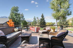 Wooden terrace with outdoor lounge area and a mountain view