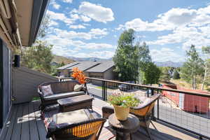 Wooden terrace with a mountain view and an outdoor living space
