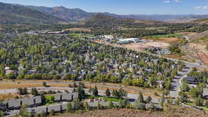 Aerial view of property's location featuring a mountain backdrop and nearby suburban area