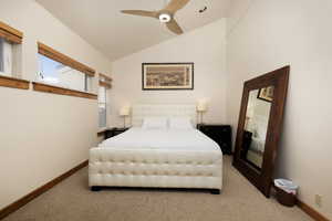 Bedroom with vaulted ceiling, carpet flooring, and ceiling fan