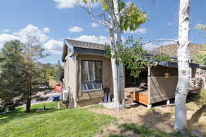 Rear view of house with a deck and a yard