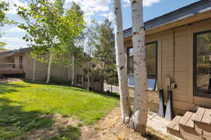 View of green lawn featuring a deck