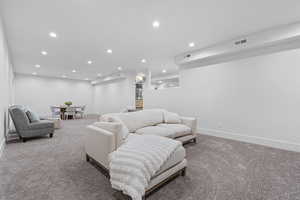 Living area with carpet and recessed lighting