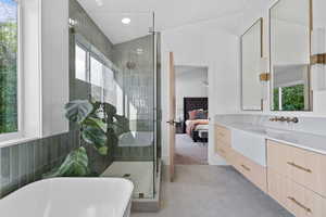 Ensuite bathroom with a freestanding bath, vanity, a stall shower, light tile patterned floors, and recessed lighting