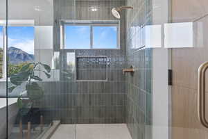 Full bath with a shower stall and a mountain view