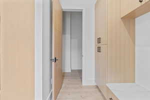 Corridor with light wood-type flooring