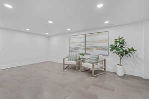 Living area with recessed lighting and baseboards