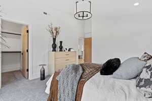Carpeted bedroom featuring a spacious closet and recessed lighting