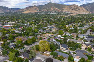 Aerial overview of property's location with a mountain backdrop and nearby suburban area