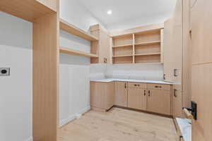 Kitchen featuring light brown cabinets, light wood-style floors, light countertops, and recessed lighting