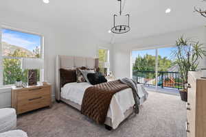 Carpeted bedroom featuring multiple windows, recessed lighting, and access to outside