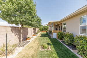 Fenced backyard featuring a ceiling fan