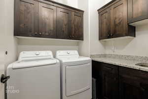 Laundry area featuring washing machine and dryer and cabinet space