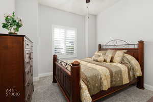 Bedroom featuring light colored carpet and ceiling fan