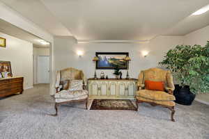 Living area with light carpet.