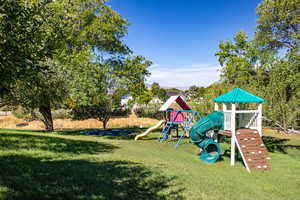 View of play area with a yard