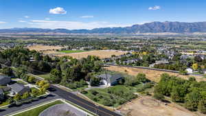 Aerial overview of property's location featuring a mountain backdrop and nearby suburban area