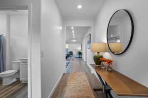 Hallway featuring dark wood-type flooring and recessed lighting