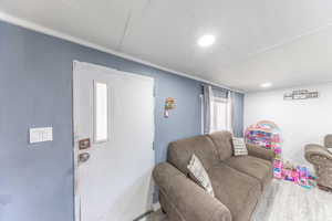 Living area with wood finished floors and recessed lighting