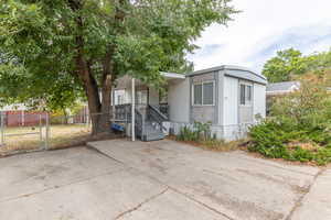 Manufactured / mobile home with a gate and covered porch