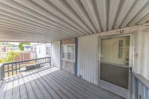 Wooden deck featuring a shed