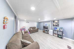 Living room with wood finished floors and recessed lighting
