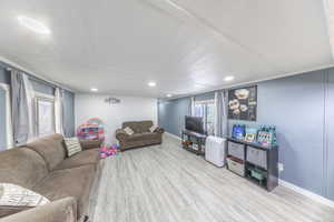 Living area featuring wood finished floors and recessed lighting